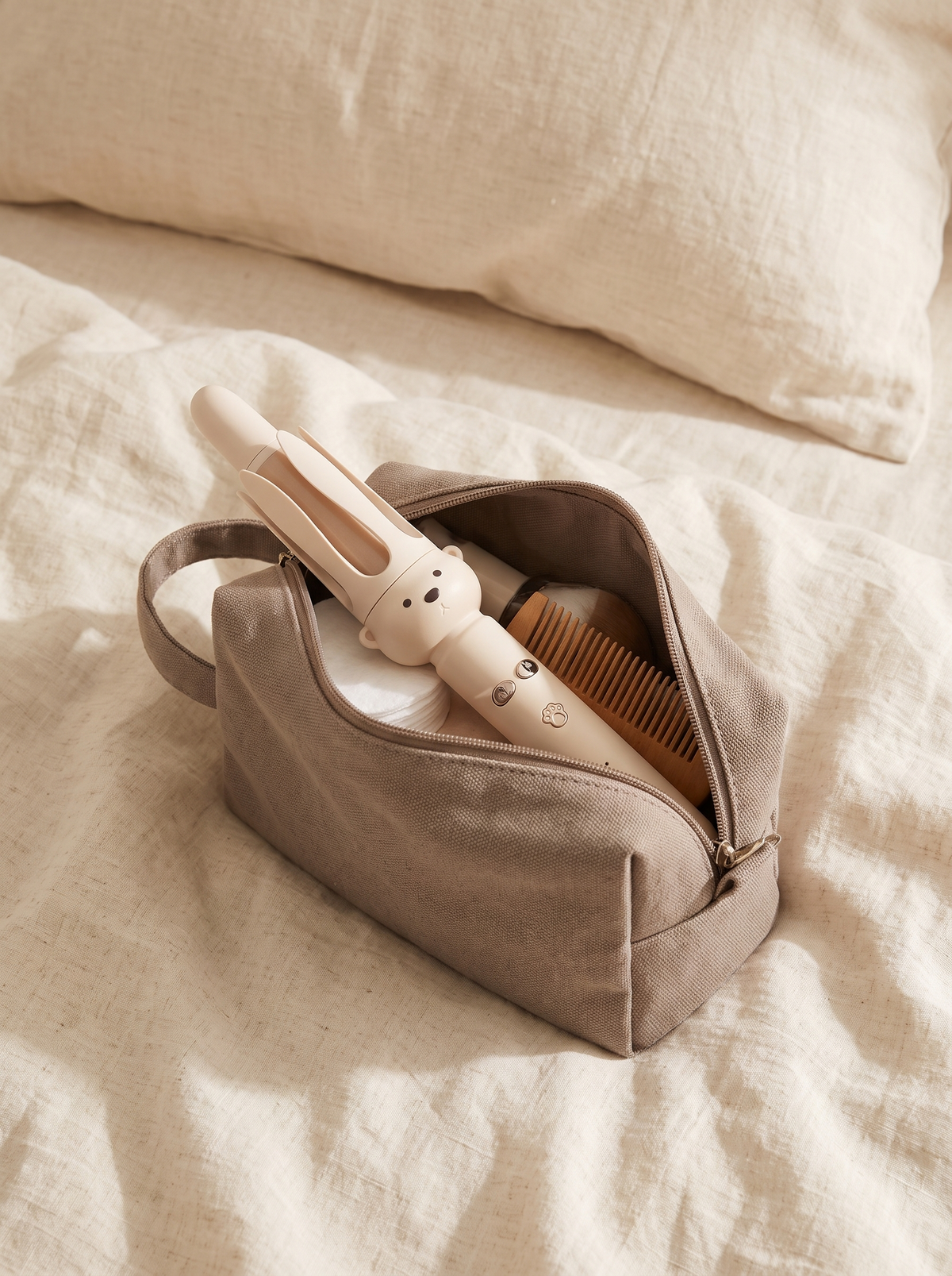 Maren curling wand packed in an open toiletry pouch